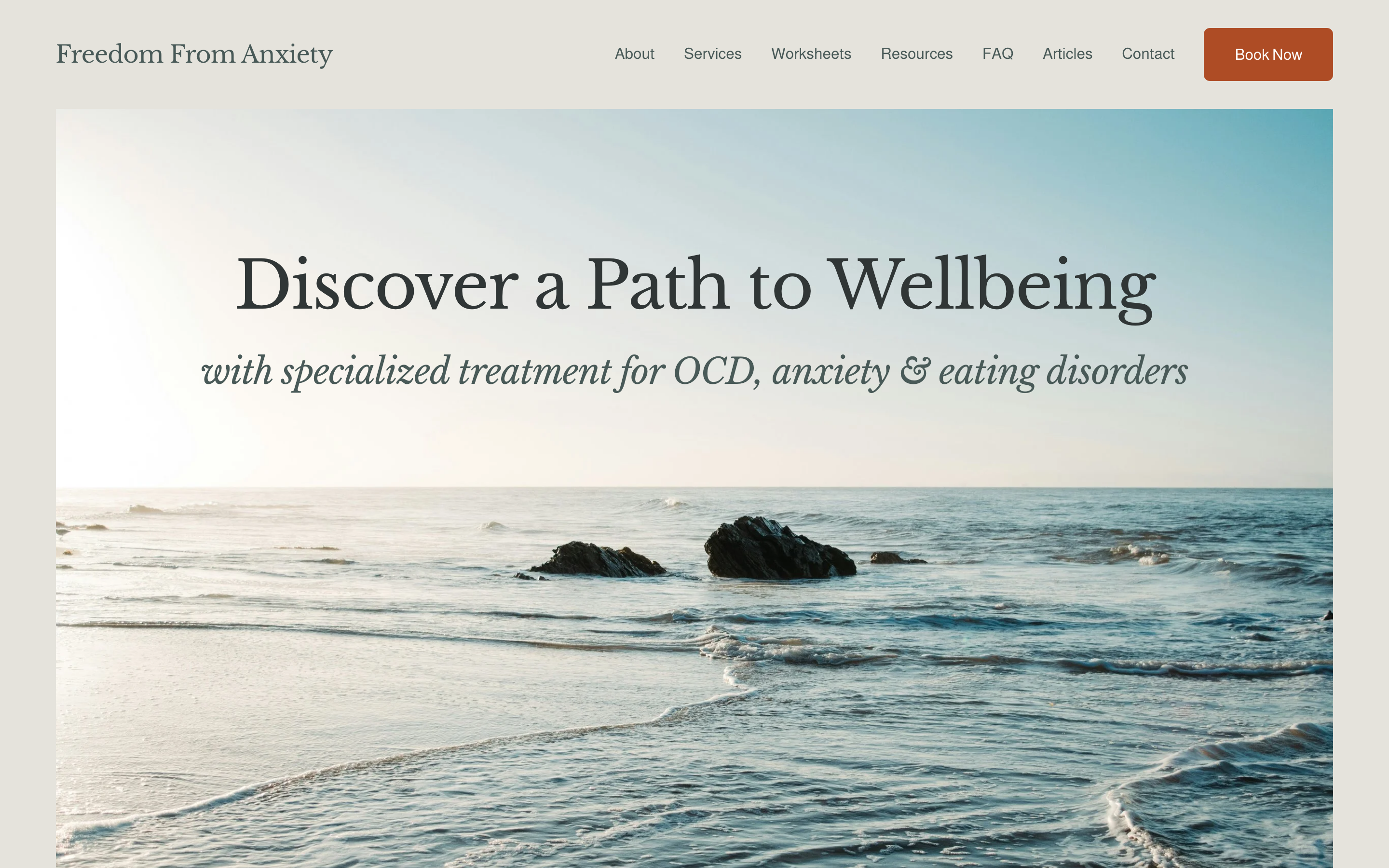 The Grace Stirling Therapy website homepage: a calm coastal design headed "Discover a Path to Wellbeing, with specialized treatment for OCD, anxiety and eating disorders", above a wide photograph of shoreline and rocks.